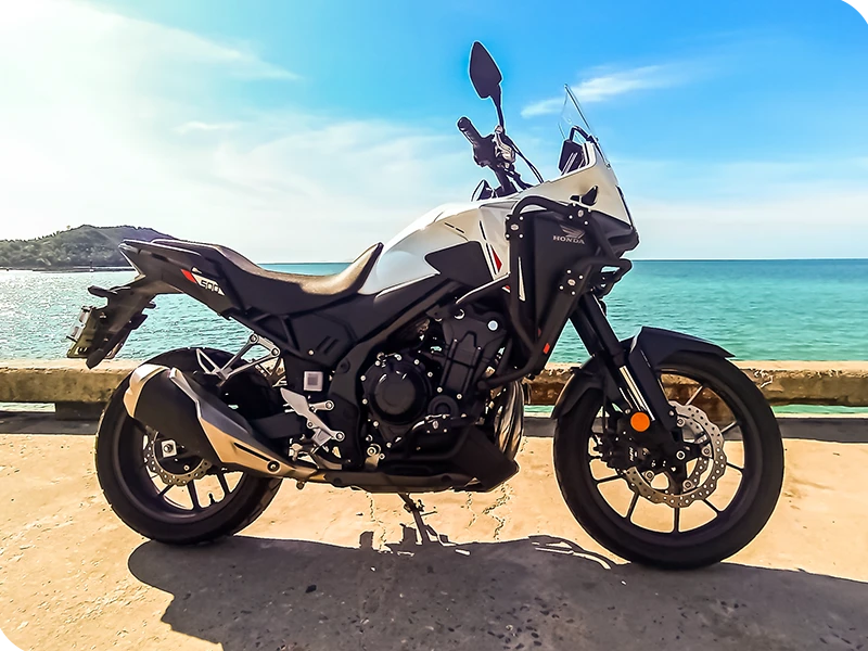 Honda NX500 adventure bike side view Ko Phangan beach